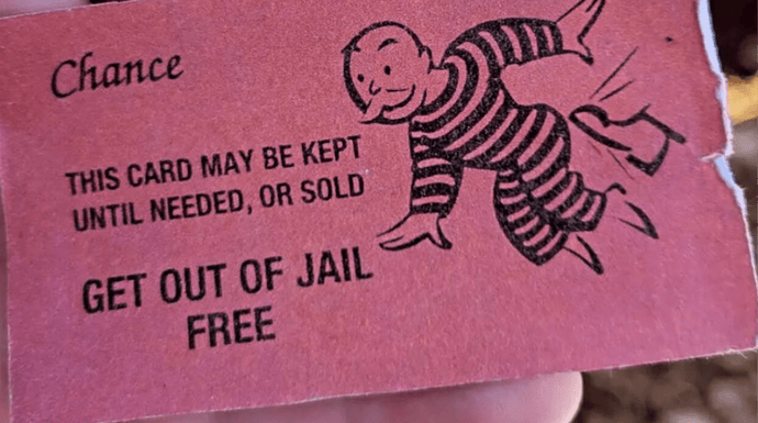 Suspect hands cop "Get out of jail free" card from Monopoly